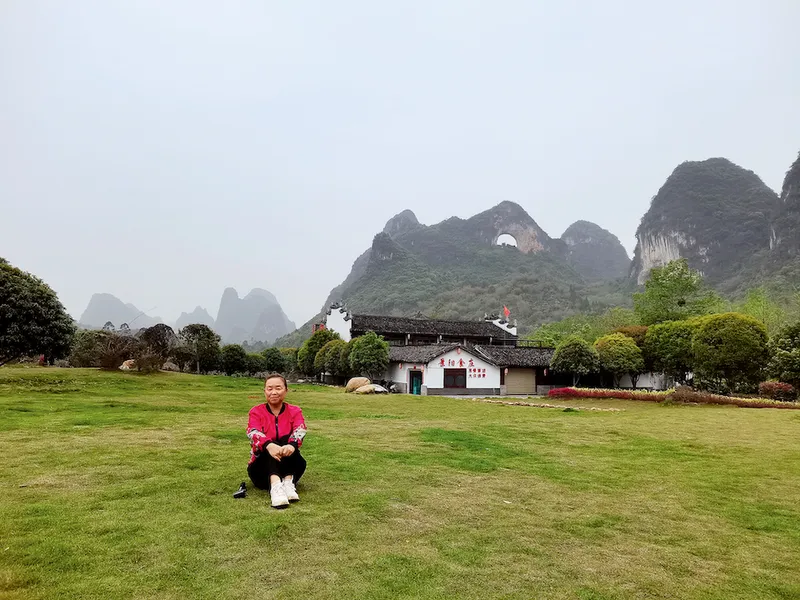 Chinese retiree, Su Min sitting and resting at Moon Mountain in Guangxi
