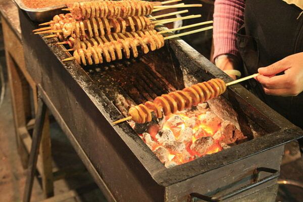 Roasted Gluten on a stick being cooked up.