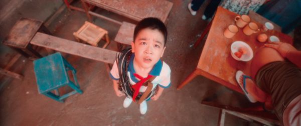 A young Chinese student looking upwards in a scene from the movie "The Champion".
