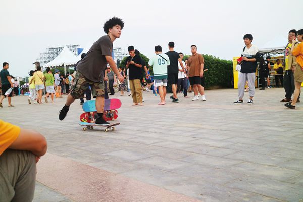 Chinese skateboarder getting ready to skate to the next show.