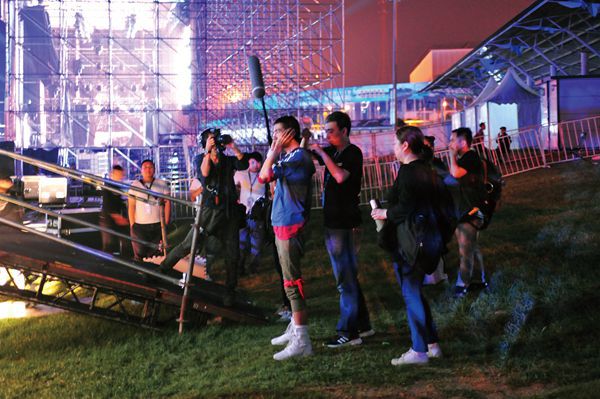 Chinese musician Pu Shu preparing to go on stage during a music festival.
