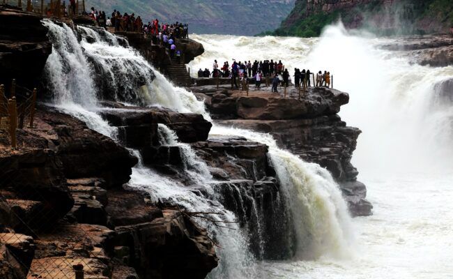 Tourists visiting the Hukou Waterfall near Shanxi and Shaanxi.