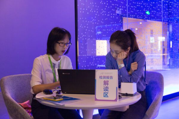 A By Health employee speaks to a Chinese customer at a gene-testing center.