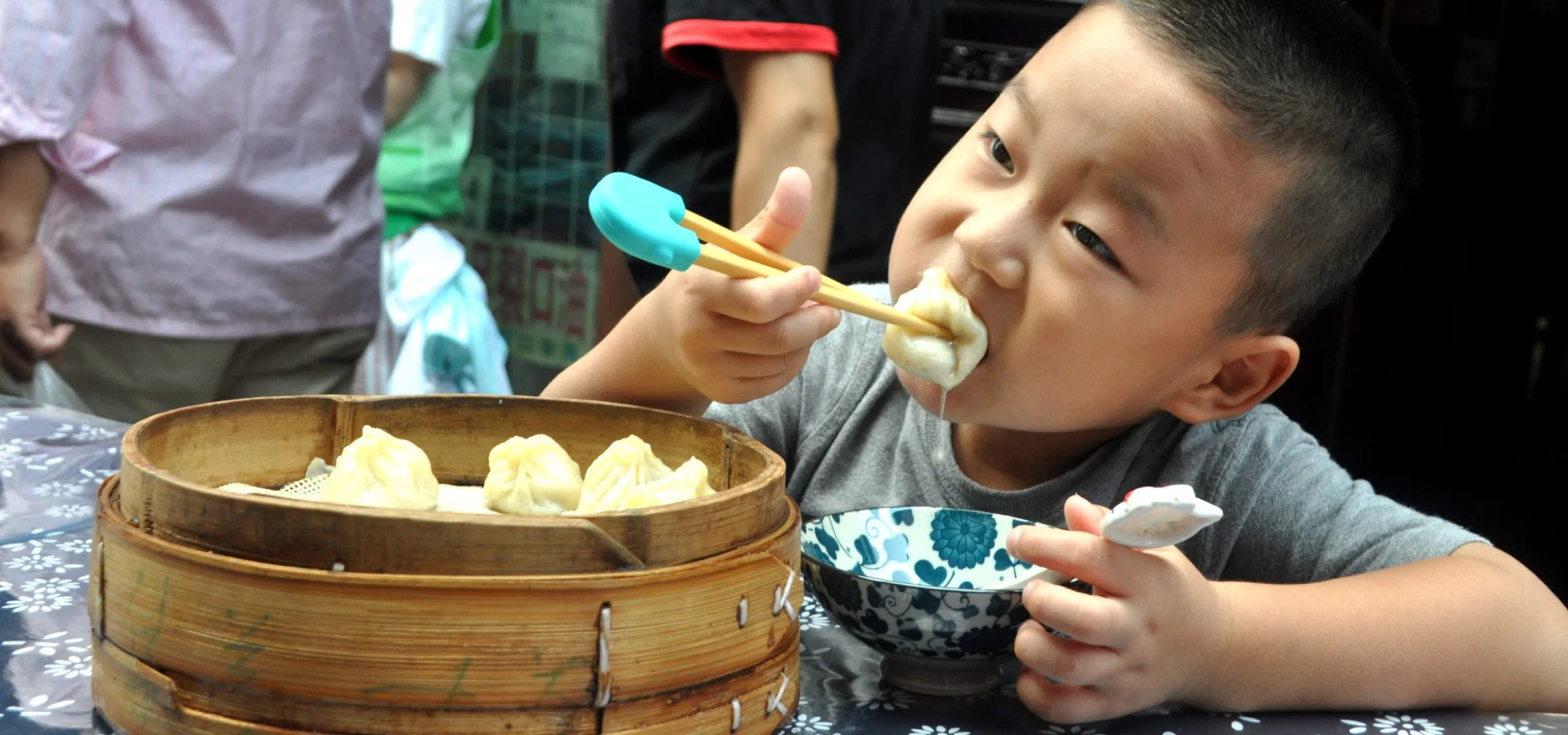 Boy eating xiao long bao