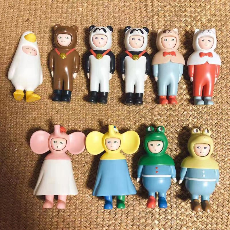 Two sets of Chinese designer toys spread out across a woven mat.