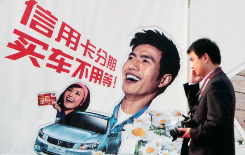Advertisements and “shopping festivals” encourage consumers to spend, Young Chinese living on debt