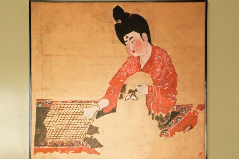 lady playing go painting