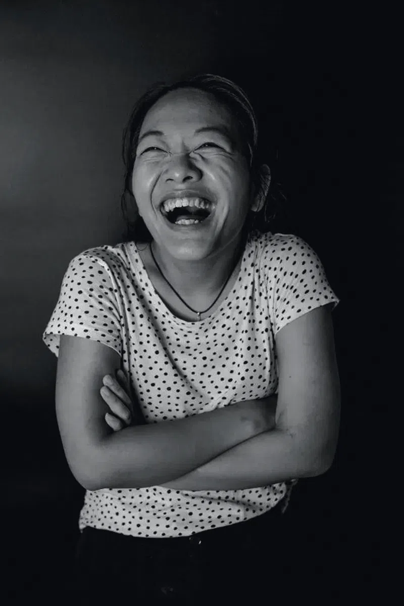 Peng Yujiao one of the inspiring and disabled Chinese women interviewed by TWOC, lets out a big smile while snapping a black and white photo.
