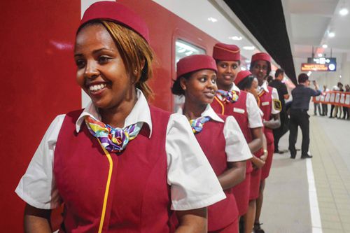 Stewardesses of Addis Ababa-Djibouti Railway react after the arrival of the first commercial train from Addis Ababa at a platform at Nagad railway station in Djibouti on January 3, 2018. From next week, Addis AbabañDjibouti Railway will connect daily between Addis Ababa and Djibouti. / AFP PHOTO / Houssein Hersi