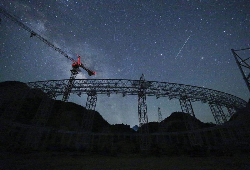 The FAST project under construction in 2014 in Pingtang county, Qiannan Buyi Autonomous Prefecture, Guizhou. Scientists hope it may be able to detect interstellar communications signals that display evidence of extraterrestrial intelligence.